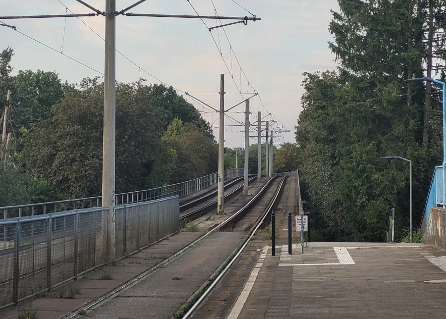 View at a tram bridge rising and then curving to the left.